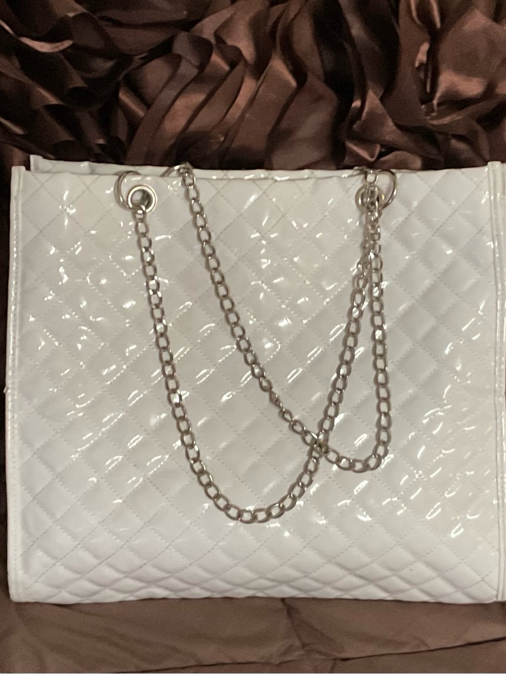 WHITE PATENT LEATHER lined, metal chains straps with inside pockets, zipper top.
